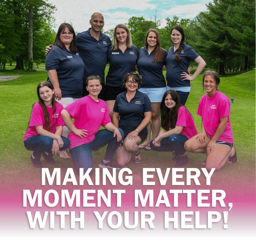 Image of Ashlie's Embrace Volunteers huddled together, with words MAKING EVERY MOMENT MATTER, WITH YOUR HELP! on the image. 