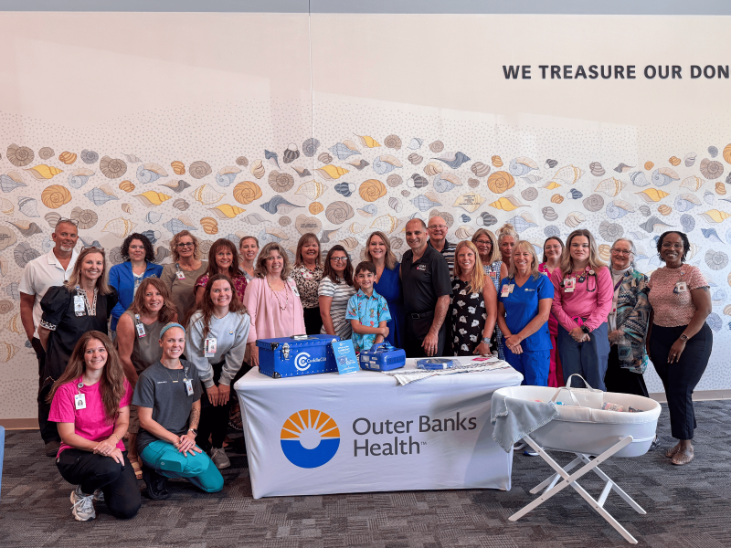 CuddleCot Donation Outer Banks Hospital - Group photo of Ashlie's Embrace team and Outer Banks Health Hospital staff.