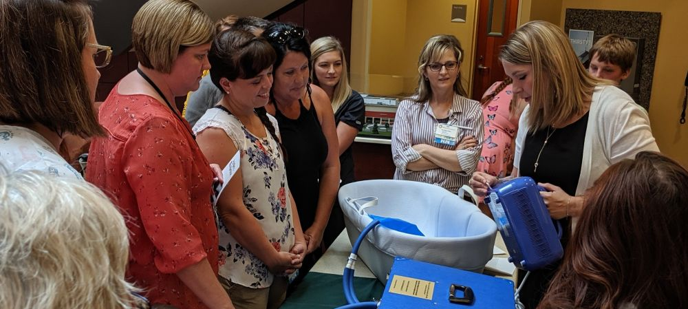 Erin showing the hospital care team how the CuddleCot is operated at a dedication ceremony at an Ohio hospital.